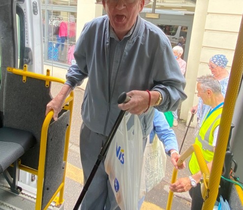 passengers getting on bus sticks tongue out